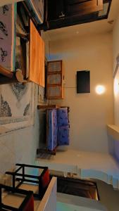 a room with a table and some baskets on the wall at EBENEZER Apartment in Diani Beach