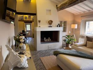 a living room with a couch and a fireplace at La Casetta di Borgo Appartamento Albero in Lajatico