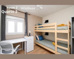 a bedroom with two bunk beds and a desk at We Host Costa da Caparica in Costa da Caparica