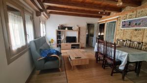 a living room with a table and a dining room at CASA PESCA VERA in Senegüé