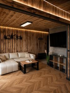 a living room with a couch and a table at Przystań Ukoya in Koniaków
