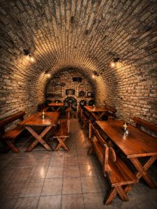 a room with wooden tables in a brick wall at Villa Retró Harmónia in Visegrád