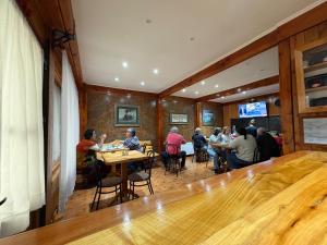 a group of people sitting at tables in a restaurant at Hostal Graciela in Pucón