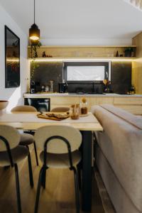 a kitchen with a table and stools in a room at Monside Resort - FIRE CABIN in Borzont