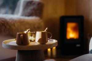 a pair of shoes sitting on a table with a fireplace at Monside Resort - FIRE CABIN in Borzont