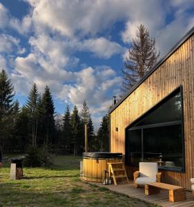 a house with a deck with a table and a bench at Monside Resort - FIRE CABIN in Borzont