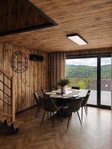 a dining room with a table and chairs at Przystań Ukoya in Koniaków