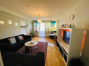 a living room with a couch and a tv at Adam1 in Uppsala