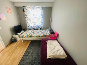 a small room with a bed and a window at Adam1 in Uppsala