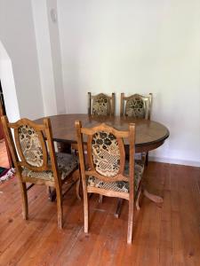 a dining room table with four chairs around it at Canovic vacation in Plav +12 photos
