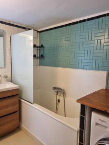a bathroom with a tub and a sink at Chateauneuf in Sadirac +35 photos