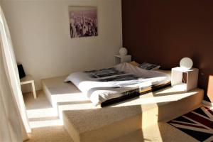 a bedroom with a bed with a table and a window at Ma chaumiere in Les Cammazes