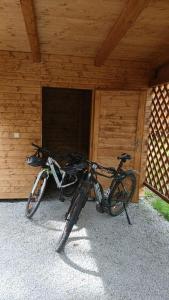 two bikes parked next to a building with a door at Komorník Residence 14 in Kunžak
