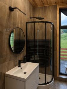 a bathroom with a sink and a mirror at Przystań Ukoya in Koniaków +18 photos