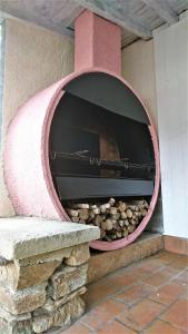 a brick oven with a pile of rocks in it at Ma chaumiere in Les Cammazes