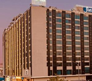 a tall building with a sign on the side of it at Golden Studio With Swimming pool in Jaipur