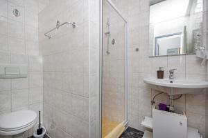 a bathroom with a shower and a toilet and a sink at Apartmani Villa Antonio in Makarska +25 photos