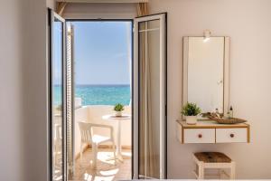 a room with a view of the ocean at Nefeli Rooms with Sea View in Kalamaki in Kalamaki
