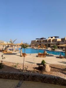 a resort with a swimming pool and some buildings at Arwaa Boutique in Dahab