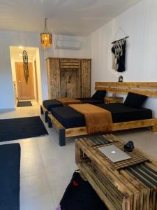 a bedroom with four beds and a table in it at Arwaa Boutique in Dahab