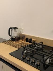 a kitchen counter with a stove top with a coffee maker at Arwaa Boutique in Dahab