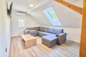 a living room with a couch and a table at Apartmaji na Pošti in Podsreda