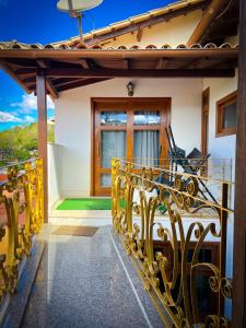 a balcony of a house with a yellow railing at Estadia Diamantes in Diamantina