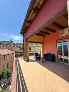 a patio with couches and tables on a building at Casa Vacanze Panoramika Santa Cruz - FAMILY ROOM in Cicerale