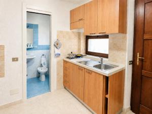 a small bathroom with a sink and a toilet at Baja Sardinia Casetta Belvedere 2 with Pool 100m from the Beach in Baja Sardinia +10 photos
