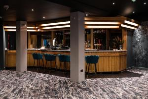 a bar in a hotel with blue stools at Park Hall Cottages ,Chorley, Preston,Lancashire in Chorley