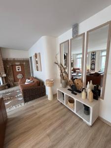 a living room with a mirror and a couch at Appart 10 pers - Lille Lambersart - Parking & Terrasses in Lambersart