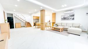 a living room with a couch and a table at Pattaya Tropical Pool Villa in Pattaya