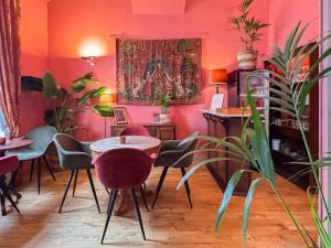 a room with a table and chairs and a painting on the wall at Hotel Botaniek in Bruges +38 photos
