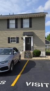 a car parked in a parking lot in front of a house at Walk to Notre Dame & Games & Concerts - 5BR-12 guests - Eddy St in Argos