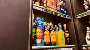 a shelf filled with lots of bottles of alcohol at Temple host in Cairo