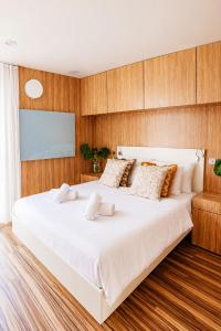 a large white bed in a room with wooden walls at Nedomek by Homester in Neslovice