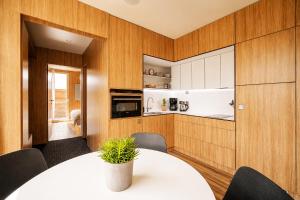 a kitchen and dining room with a white table and chairs at Nedomek by Homester in Neslovice +45 photos