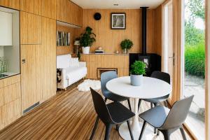 a room with a table and chairs and a bedroom at Nedomek by Homester in Neslovice