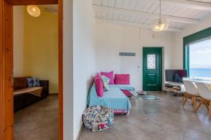 a bedroom with a bed and a living room with a table at Akteon Rooms in Agia Galini