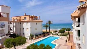 an apartment with a swimming pool and the ocean at Talima Vyb Dénia in Denia