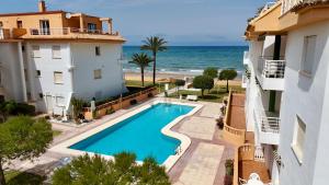an apartment with a swimming pool and a view of the ocean at Talima Vyb Dénia in Denia