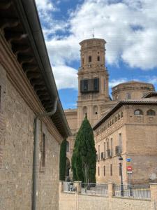 a building with a clock tower on top of it at Hospedería de Alesves in Villafranca