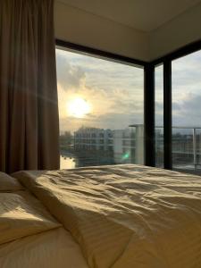 a bedroom with a bed and a large window at SolMarina Apartment for Rent in Wiślinka