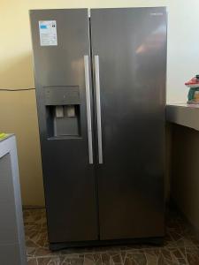 a stainless steel refrigerator in a kitchen at La Ruta in Paracas