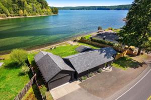 an aerial view of a house next to the water at Seal Cove in Lilliwaup