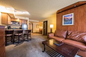 a living room with a couch and a table at The Grand Lodge, A Vail Resorts Property in Mount Crested Butte