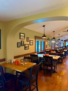 a dining room with wooden tables and chairs at Glacier Highland Motel in West Glacier