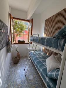 a small room with a bunk bed and a window at Crueza de ma in Bonassola
