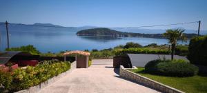 a walkway with a view of a body of water at Sea & Mountain View Apartment in Chalkida