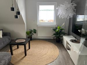 a living room with a couch and a table at Auszeit in Melsungen